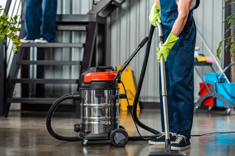 cropped view of cleaner in uniform cleaning floor 2023 11 27 05 07 51 utc